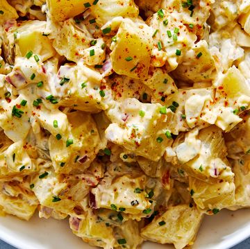 classic potato salad with pickles, onions, and topped with paprika and chives