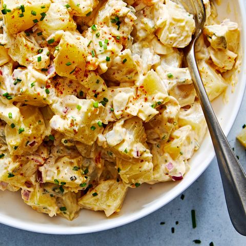 classic potato salad with pickles, onions, and topped with paprika and chives