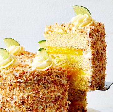 a layered coconut cake filled with lime curd and covered with toasted coconut
