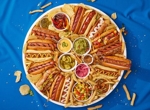 tray full of hot dogs with fun toppings