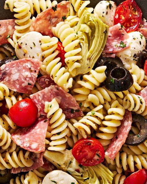italian inspired pasta salad with cherry tomatoes, mozzarella, black olives, artichokes, and salami