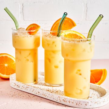 painkiller cocktails garnished with oranges on a tray