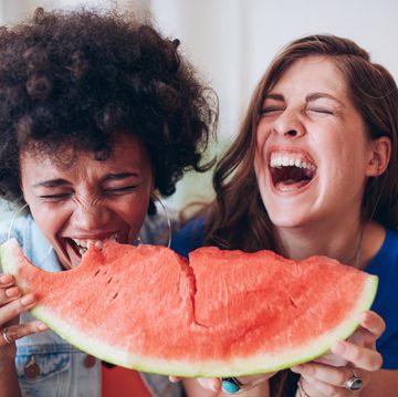 two young girls enjoying a watermelon